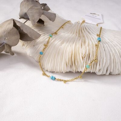 Golden necklace with small blue beads