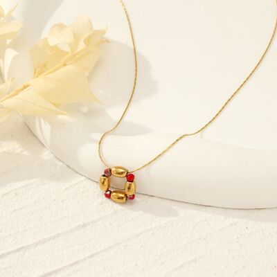Golden necklace with red pendant