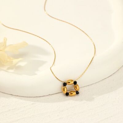 Golden necklace with black pendant