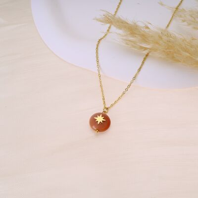 Golden necklace with star pendant and red stone