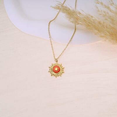Golden necklace with orange sunray pendant