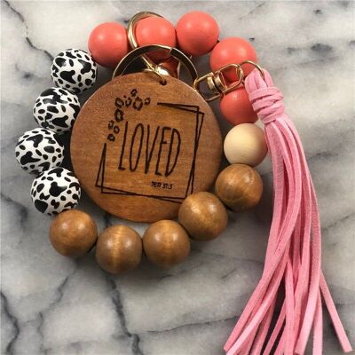 Llavero de pulsera con cuentas de madera y borlas