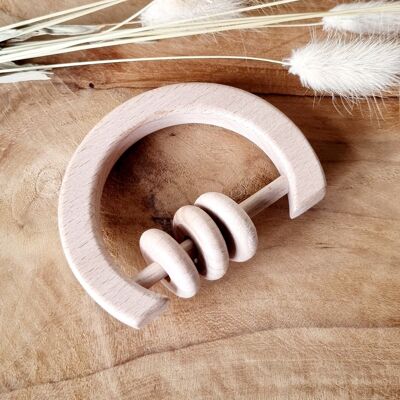 Wooden rattle with rings around