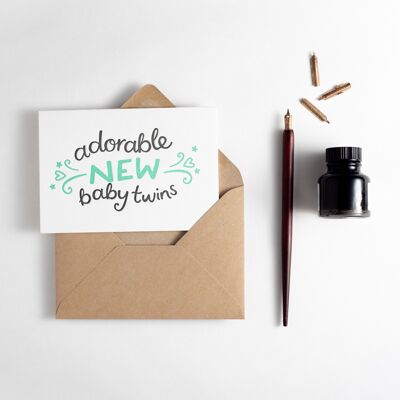 Adorable nuevo bebé gemelos tipografía tarjeta de felicitación