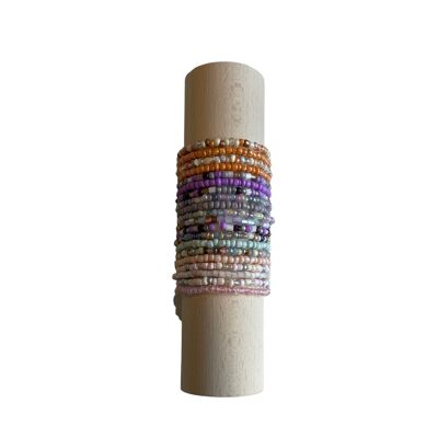 Women's bracelets, glass bead bracelets on a wooden roll.