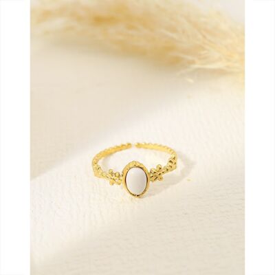 Golden ring with white stone