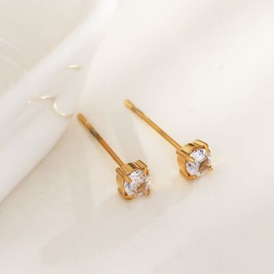 Simple golden earrings with rhinestones