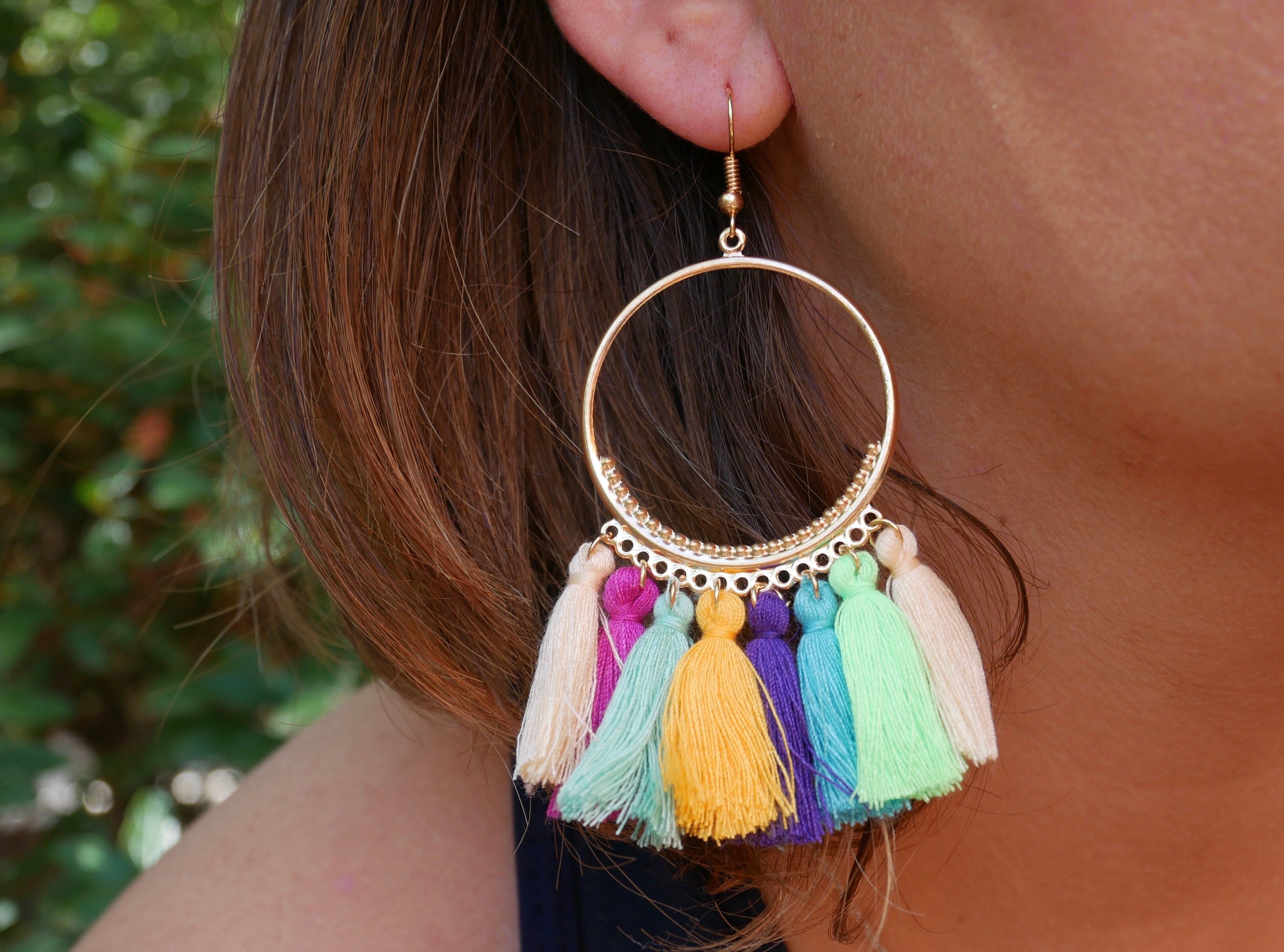 Golden hoop earrings and colored pompoms
