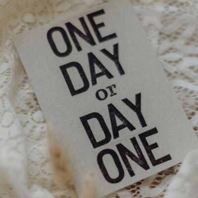 Stamped postcard "One day or day one?"