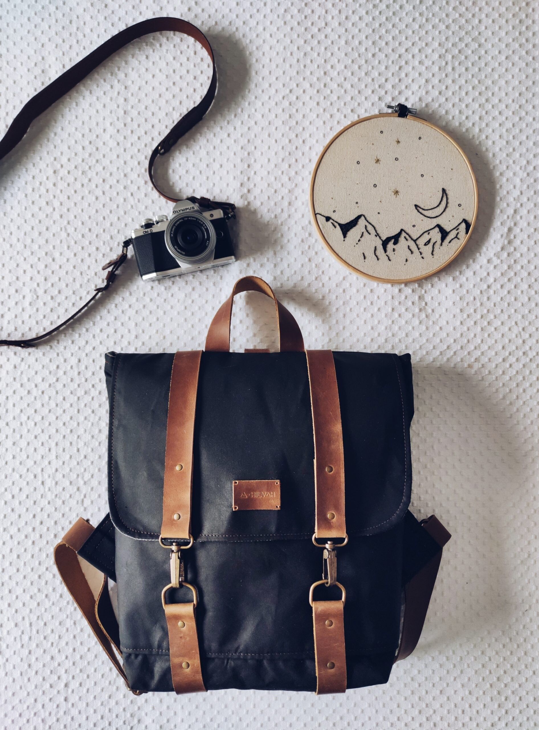 Unisex black backpack made of waxed canvas and brown leather