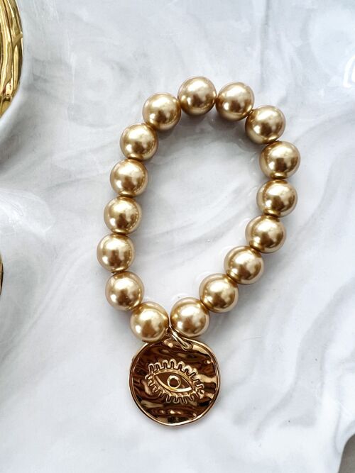 Big gold pearl bracelet with eye coin