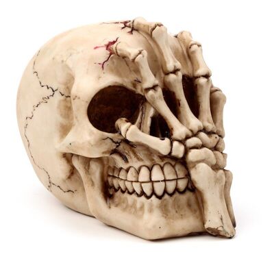Tête de crâne horrible avec main de griffe de squelette