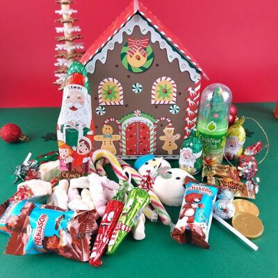Lebkuchen-Weihnachtshaus gefüllt mit Weihnachtssüßigkeiten und Pralinen