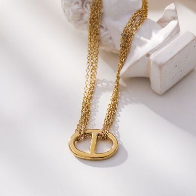 Gold multi-chain necklace connected by a ring