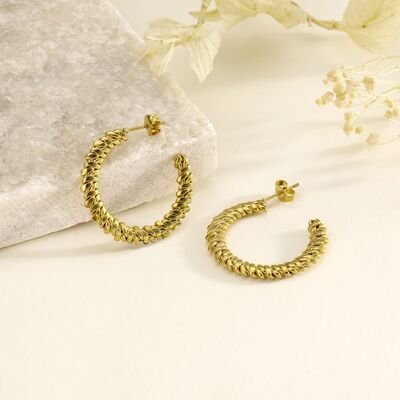 Gold hoop earrings with tight braid