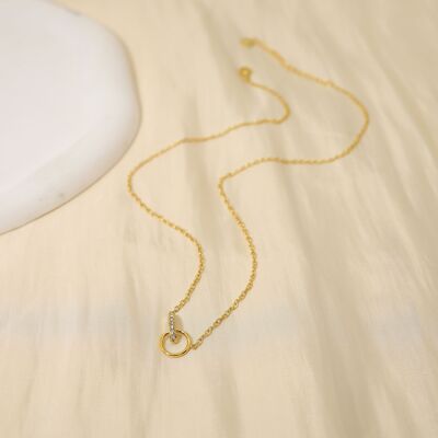 Golden chain necklace with barred circle with rhinestones
