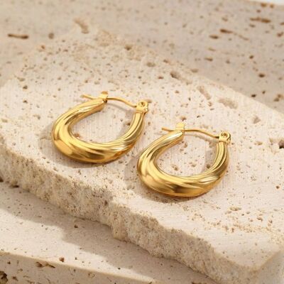 Gold hoop earrings with wavy lines
