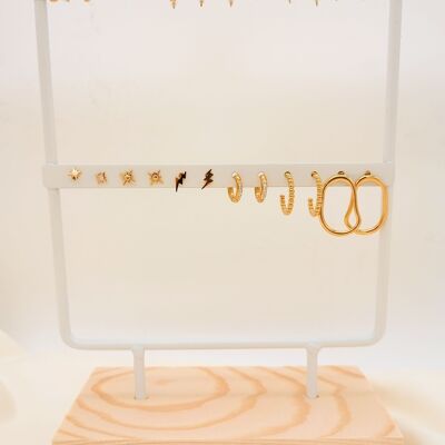 Set of 12 pairs of gold earrings on white displays
