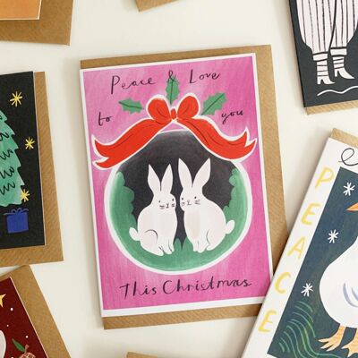 Cartolina di Natale con coniglietti nella tana