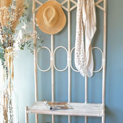 Reception bench with limed white rattan coat rack