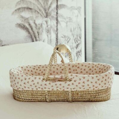 Ecru bassinet covering with pink floral patterns