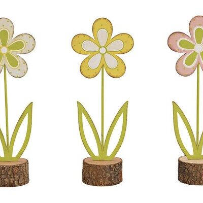 Metal flower stand on pink / pink wooden trunk