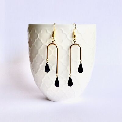 Unstructured architectural earrings with gold graphics and black enamel