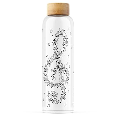 Botella de vidrio única con clave de sol y partitura.