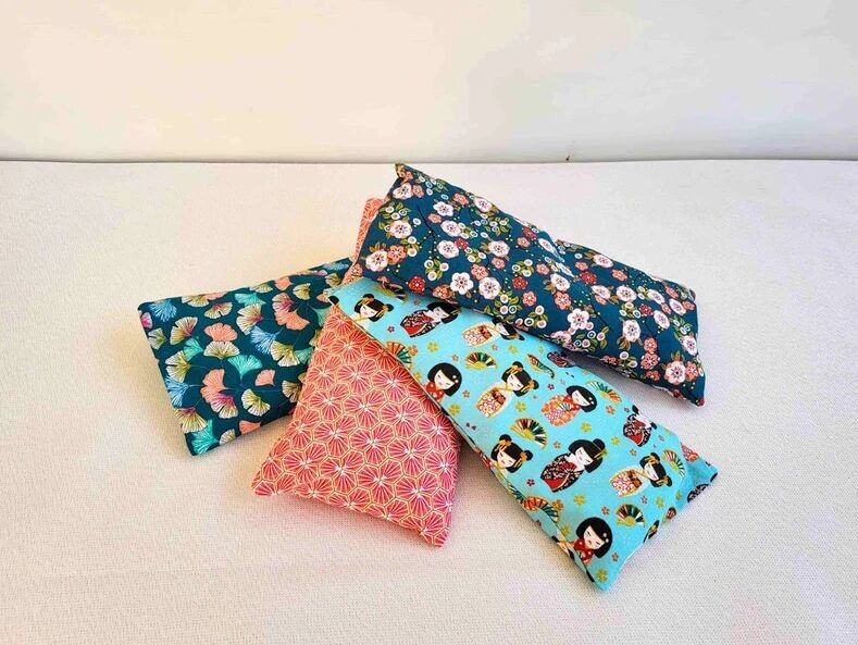 Small dry hot water bottle with removable cover with wheat grains, cherry stones or wheat grains