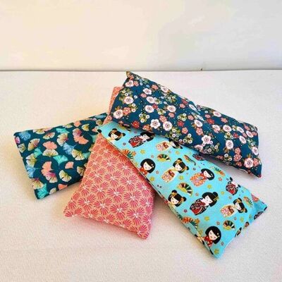 Small dry hot water bottle with removable cover with wheat grains, cherry stones or wheat grains