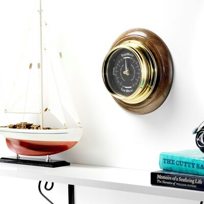 Reloj Prestige Tide hecho a mano en latón macizo con esfera de aluminio negro azabache, montado en un sólido soporte de pared de roble oscuro inglés