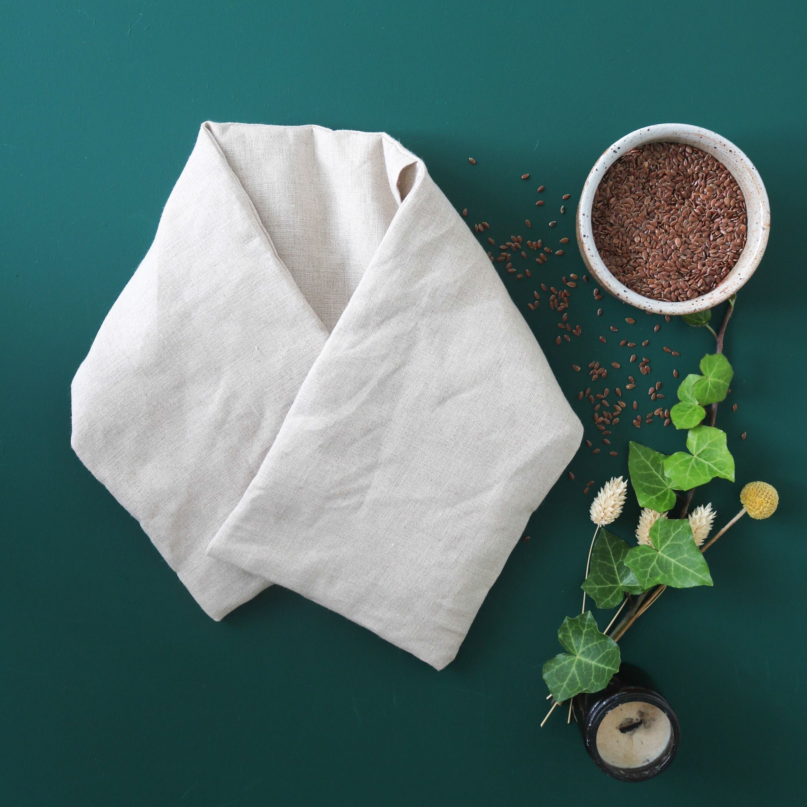 Long cervical hot water bottle with its washable cover