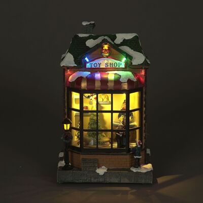 Ilumina la escena navideña de la tienda de juguetes con un árbol giratorio y luces LED