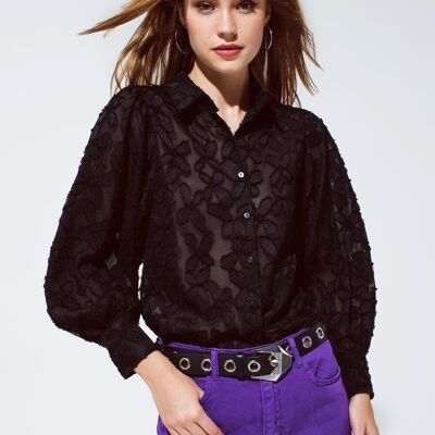 Blusa nera con dettagli floreali