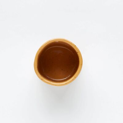 Handmade yellow ceramic cup