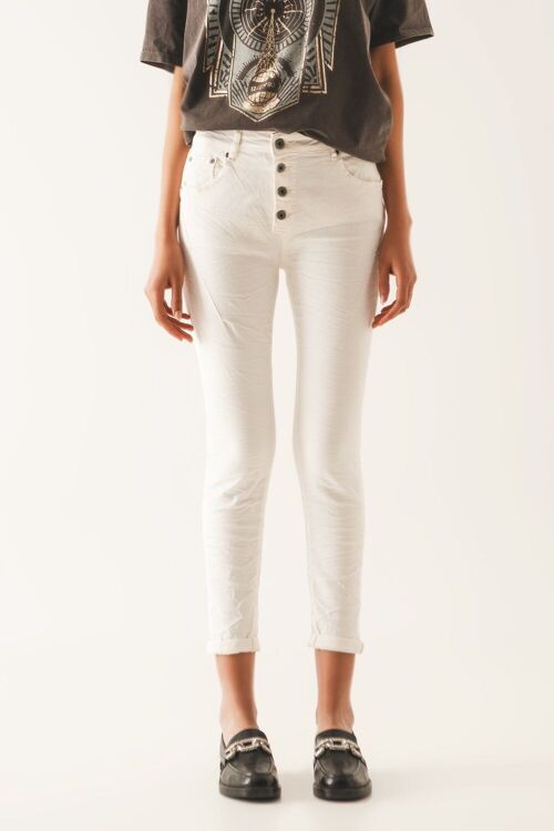 Exposed buttons skinny jeans in cream