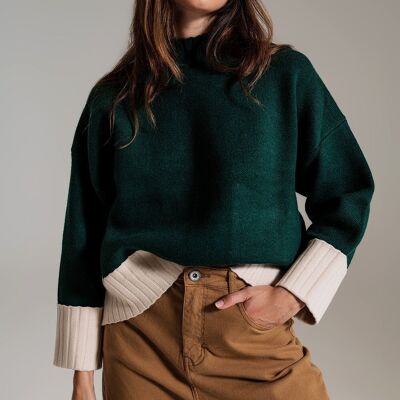 green jumper with white ribbed cuffs and hem