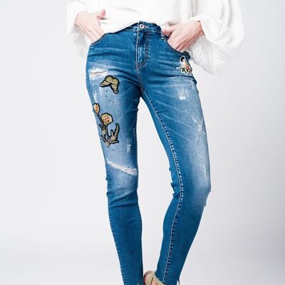 Jeans skinny strappati con toppe ricamate
