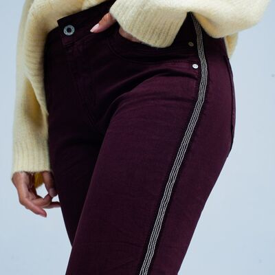 Maroon skinny jeans with metal side stripe