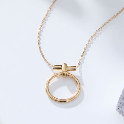 Gold chain necklace with round pendant and bar in the chain
