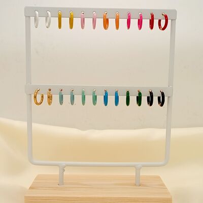 White display with 12 pairs of colorful earrings