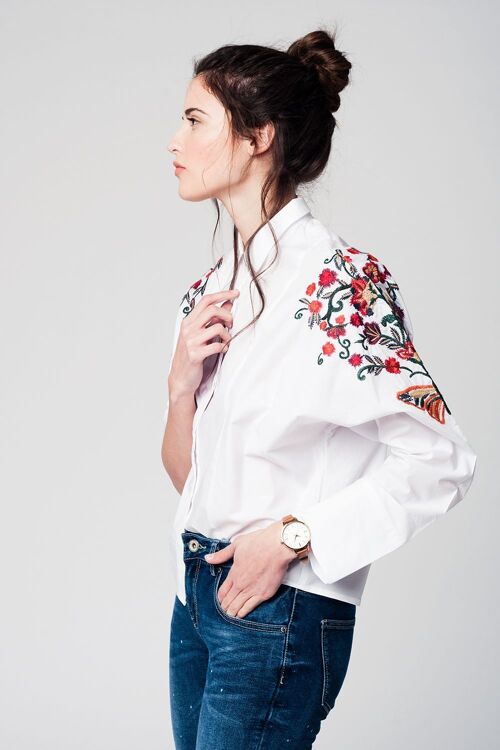 White blouse with flower embroidery detail on the sleeves