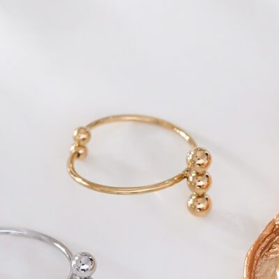 Thin golden ring with triple balls