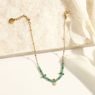 Bracelet chaîne dorée avec perles bleues et pampille ronde