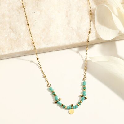 Golden chain necklace with blue stones and round pendant
