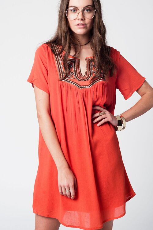 Mid-leg orange dress with decorative detail at the neckline