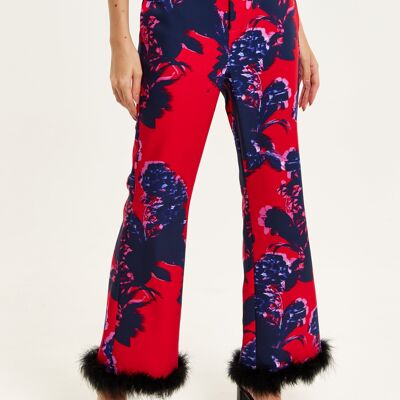 Pantaloni sartoriali rossi con stampa floreale liquorosa con finiture morbide in nero