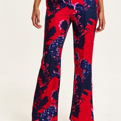 Pantaloni rossi sartoriali con stampa floreale liquorosa
