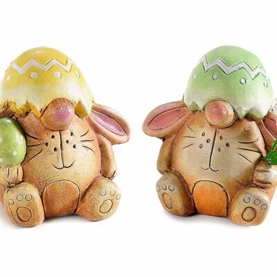 Conigli pasquali decorativi con uova in terracotta colorata da appoggiare