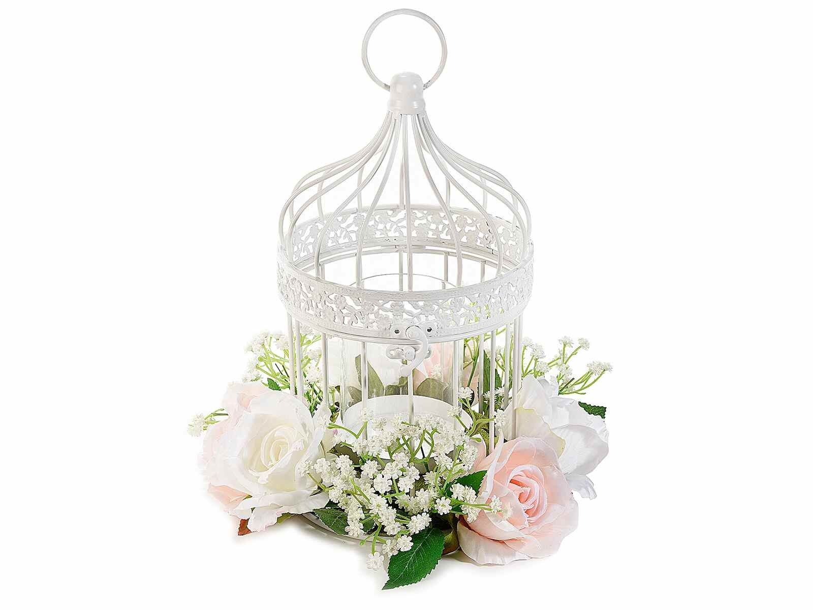 White metal cages with artificial roses and candle vase